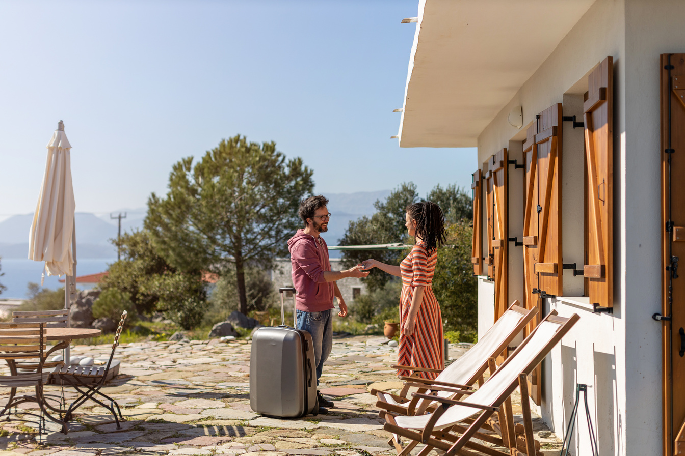 Host welcoming guest at house rental
